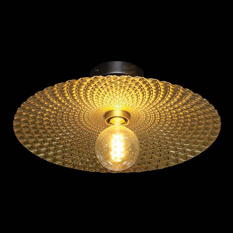 Gold textured ceiling light fixture with a lit bulb on a black background