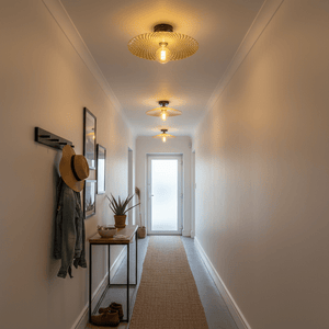 A well-lit hallway featuring three flush-mount ceiling lights, enhancing the modern decor with warm tones.