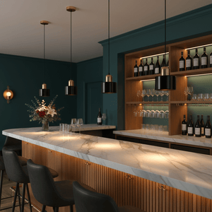 Three black and gold pendant lights hang above a marble bar in a stylish interior with teal walls.