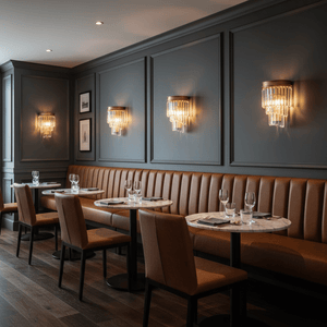 Elegant indoor scene featuring Greta Satin Gold Crystal Wall Lights illuminating a stylish dining area.