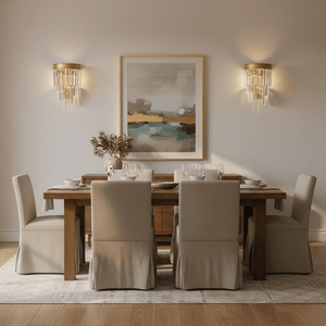 Elegant dining room featuring the Greta Satin Gold Crystal Wall Light beside a framed artwork.