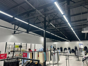Retail ceiling installation showing the Gyro dual optic linear fittings in a store environment.