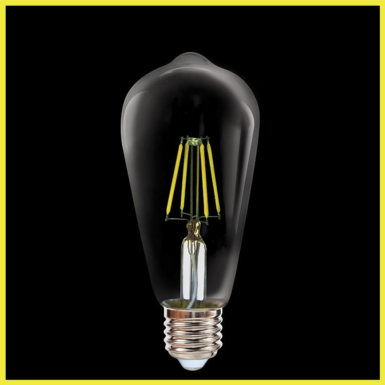 Clear light bulb with visible filaments on a black background