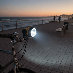 Bicycle headlight on a sidewalk by the ocean at dusk