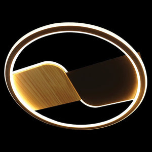 Decorative wall light fixture with a circular design on a black background