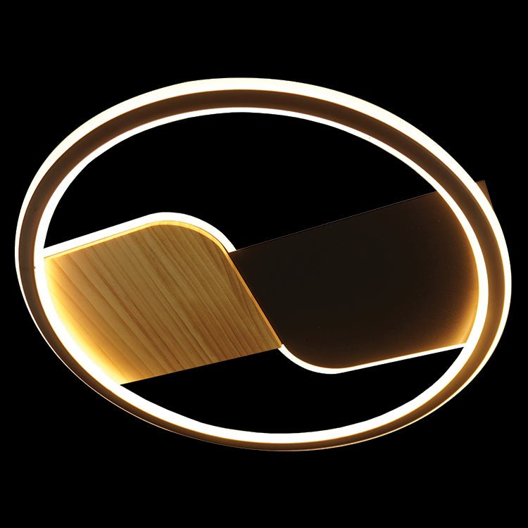 Decorative wall light fixture with a circular design on a black background