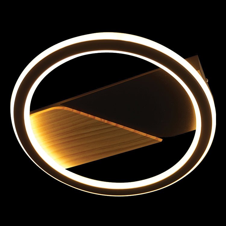 Modern ceiling light fixture with circular design on a black background