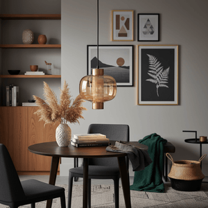 Stylish gold glass pendant light hanging above a round dining table with decorative elements.