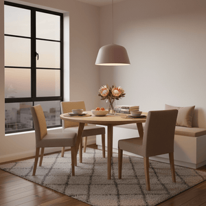 Soft pink cupcake-style pendant light hanging over a round wooden dining table in a bright room.