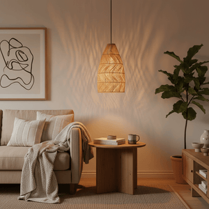 Rattan pendant light casting warm light above a cozy sofa with decorative pillows and a side table.