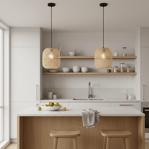 Two Adaya Rattan Pendants hanging above a kitchen island with a bowl of fruits and minimalist decor.