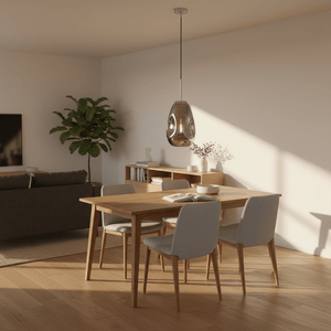 Smokey glass and chrome pendant light hanging above a wooden dining table in a bright modern room