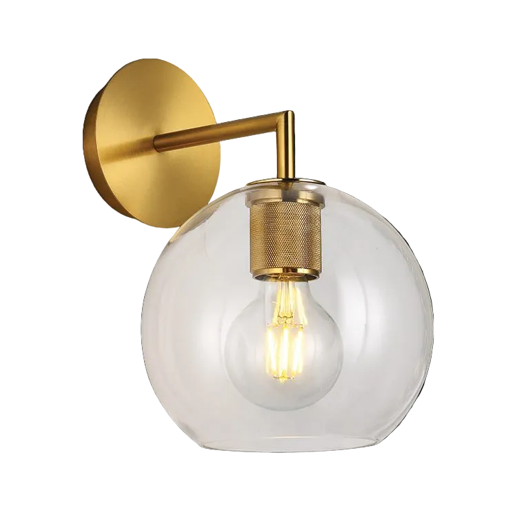 Gold wall light with a clear spherical glass shade and visible filament bulb