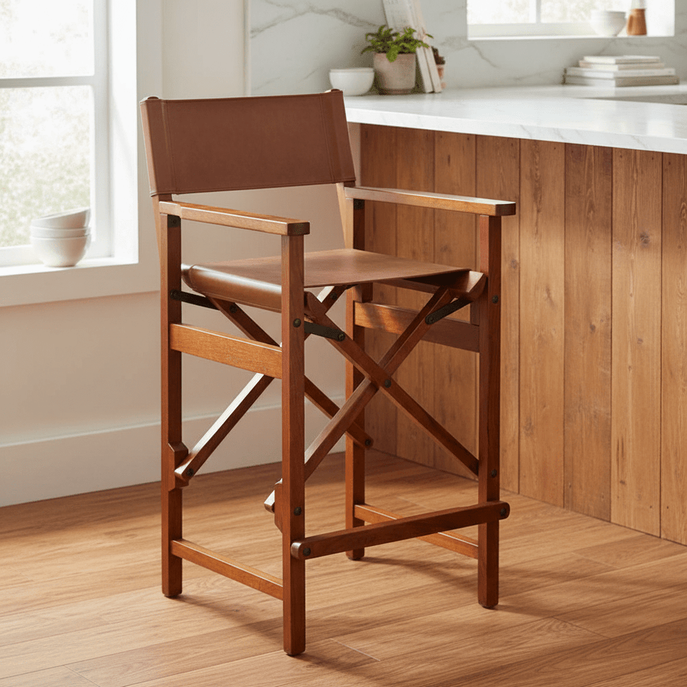 Acacia Leather Director Counter Chair in a bright room with wooden flooring and a marble countertop.