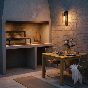 Outdoor patio with a lit wall lantern, dining table set, and a built-in grill area.