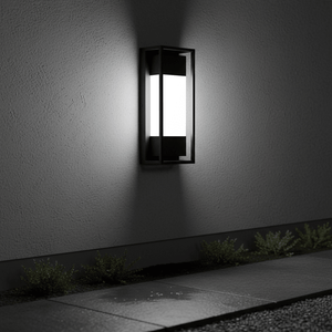 Textured black outdoor LED wall light mounted on a wall, illuminating a pathway with soft light.