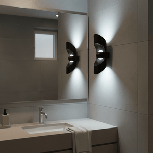 Two Uniq Up & Down LED Wall Lights mounted on a bathroom wall, illuminating a mirror and sink area.