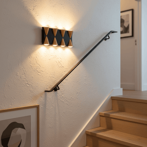 Modern up-and-down outdoor wall light illuminating a staircase, enhancing safety and ambiance.