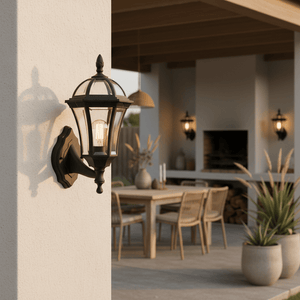 Eclipse 6 Panel Wall Light mounted on a wall, illuminating a cozy outdoor dining area with a table and chairs.