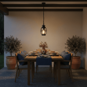 Sey Outdoor Pendant Light hanging above a beautifully set patio dining table with plants in the background.