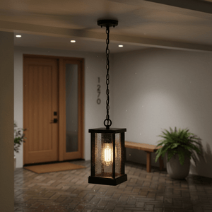 Lantern-style pendant light hanging in a covered outdoor area, illuminating a doorway and patio.