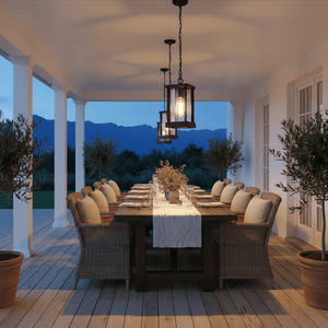 Three Atlantis Outdoor Pendant Lights hang above a beautifully set outdoor dining table on a covered patio.