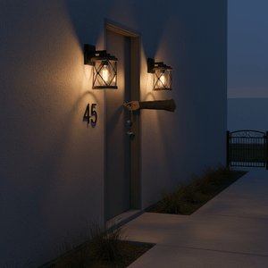 Two Leon Wall Lights illuminate a front door as a hand reaches for the door handle, enhancing safety and visibility.