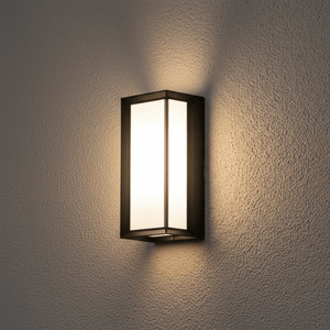 Black rectangular outdoor wall light mounted on a textured wall, emitting warm white light.