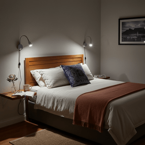 Cozy bedroom scene featuring a bed with a wooden headboard and two LED wall lights mounted on either side.