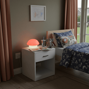 Mushroom cap night light glowing softly on a bedside table next to a bed with colorful bedding.