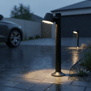 Coastal bollard light illuminating a wet pathway, rain falling, with a car in the background.