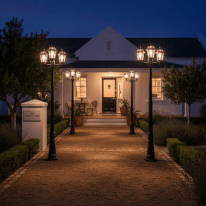 Eclipse 3 Light Poly Post Lamp illuminating a gravel pathway leading to a home entrance at dusk.