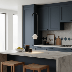 Luna Long G9 pendant light in black hanging above a kitchen island with a bowl of lemons.