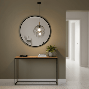 Stylish black pendant light hanging above a wooden console table with a round mirror and potted plant.