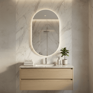 Oval LED mirror with touch switch above a modern bathroom vanity, featuring marble walls and a plant.
