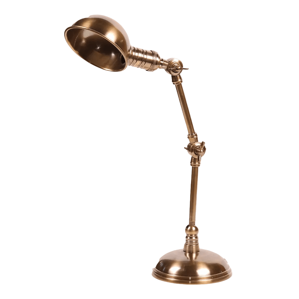 Antique brass desk lamp with adjustable articulated arm, domed shade and round base on transparent background
