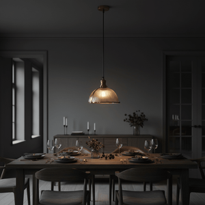 Salina Hanging Lamp in antique brass above a dining table, showcasing ribbed glass shade and warm glow.