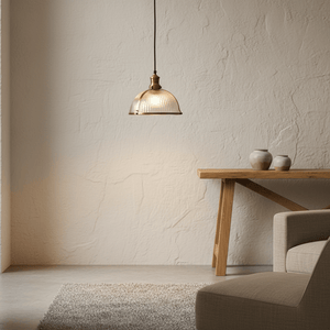 Salina Hanging Lamp in antique brass above a wooden table, ribbed glass shade visible, warm ambiance.