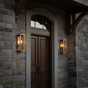 Belfort Lantern Box in antique brass mounted beside a wooden front door on a stone wall.