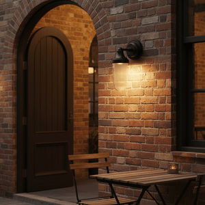 Fabio Hanging Lamp in Matt Black mounted on a brick wall, illuminating a cozy outdoor seating area.