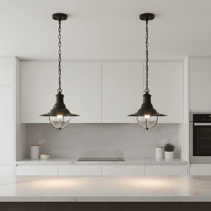 Two Wellington Hanging Lamps in matt black above a kitchen island, featuring wide flared shades and wire cages.