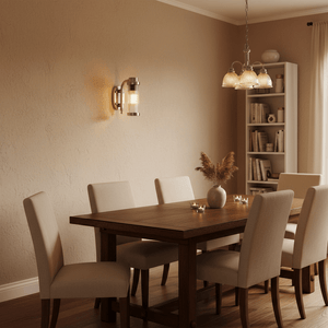 Antique silver Milo Wall Lamp mounted on a textured wall, illuminating a cozy dining area with a wooden table and soft decor.