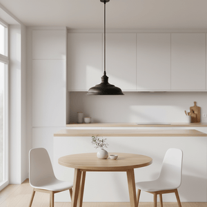 Ducasse Hanging Lamp in matt black above a round wooden table in a modern kitchen setting.