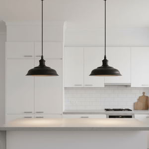 Two Ducasse Hanging Lamps in matt black above a modern kitchen island with a light countertop.