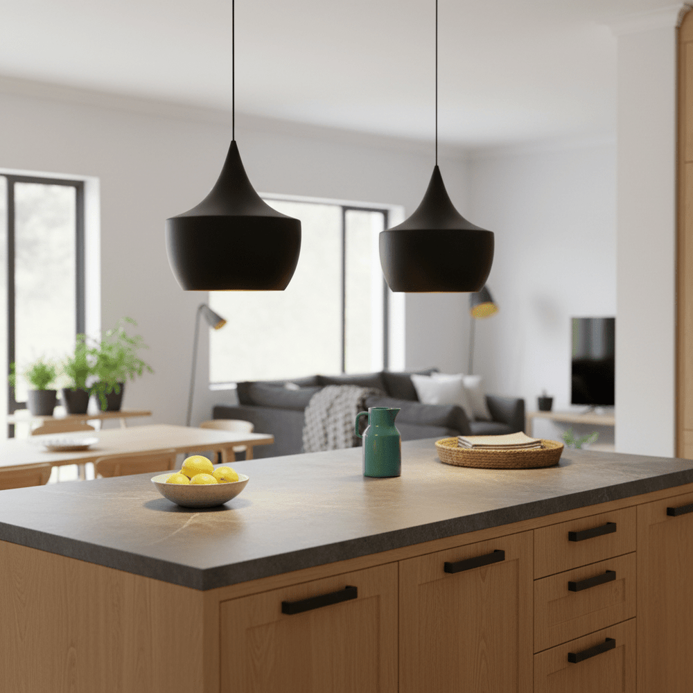 Two Miso Nordic Pendant Lights hang over a kitchen island with a bowl of lemons and a green pitcher.