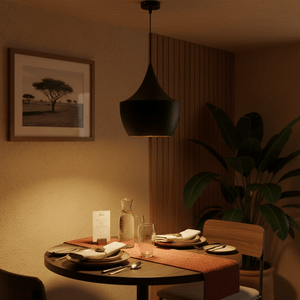 Miso Nordic Pendant Light hanging over a dining table set with plates and glasses, creating a warm ambiance.