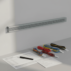 Grey slotted trunking mounted on a wall with organized cables and a cable schedule on a table.