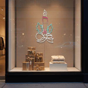 Candle motif LED Christmas lights displayed in a retail window with gift boxes and a cozy blanket.