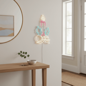 Colorful LED candle motif lights mounted on a wall above a wooden console table with a small plant.
