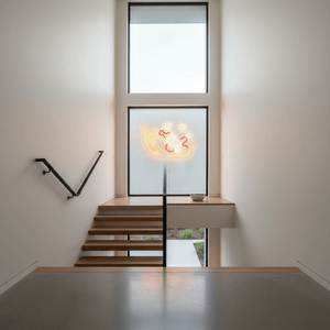 Santa sled motif lights glowing in a modern stairwell window, creating a festive atmosphere.